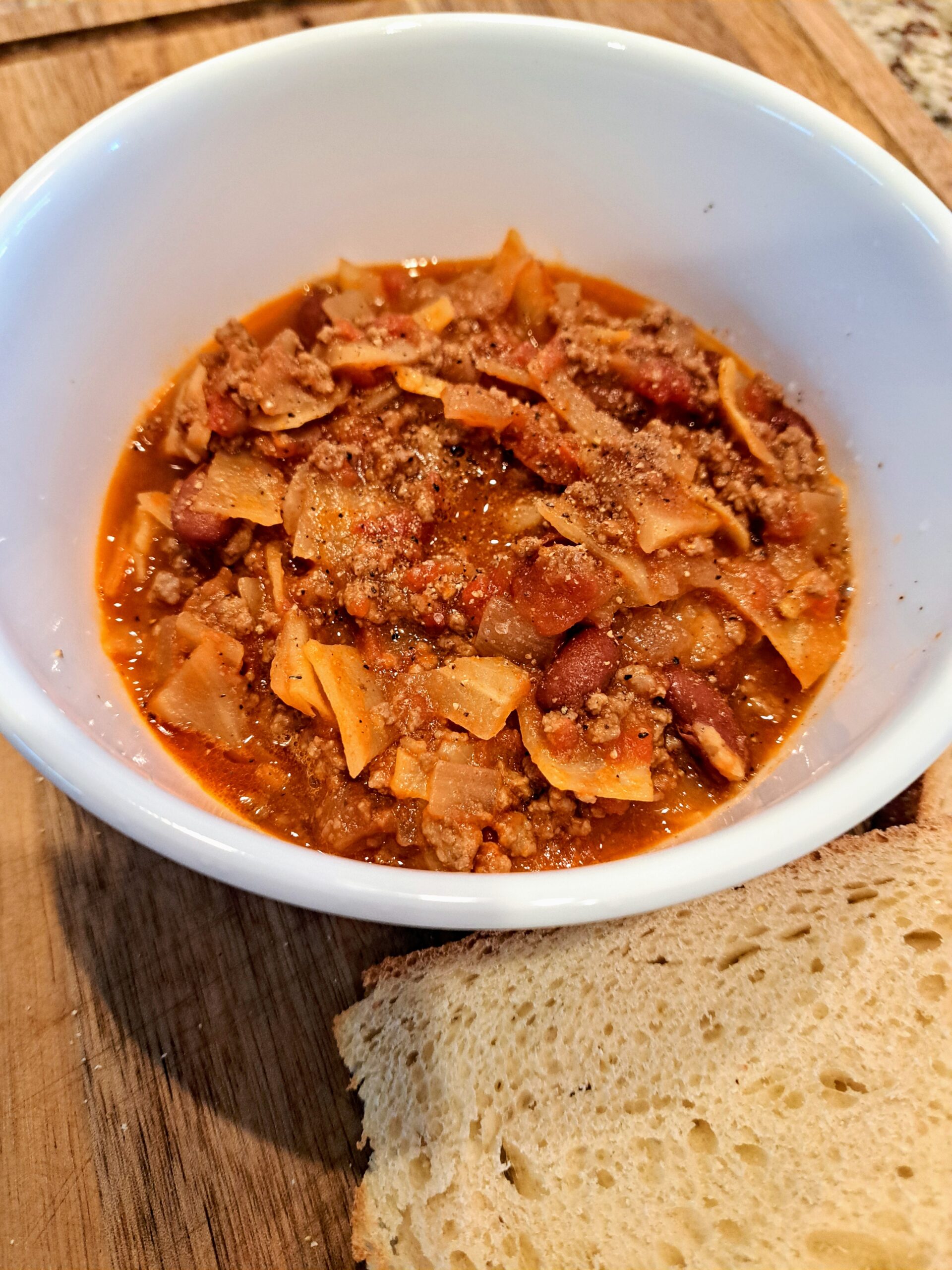 Beef and Cabbage Soup in a bowl on a cutting board